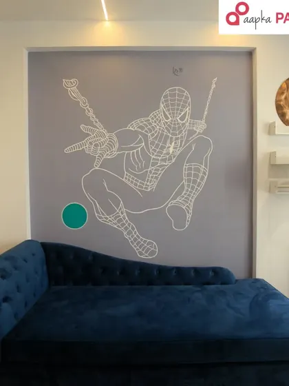 The finished Spiderman mural in a cozy room corner, perfectly complementing the blue chaise lounge. It creates a cool hangout spot for any fan.