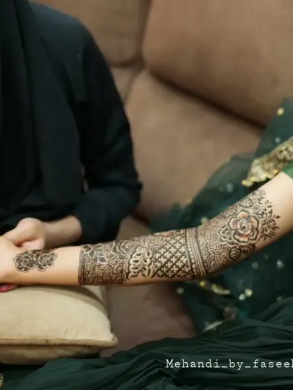 A beautiful shot of the bridal henna session, showing the art coming to life.