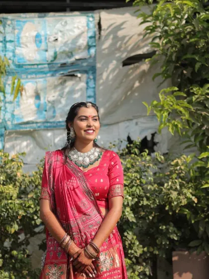 A radiant look for a Lagan Lekhan ceremony. The bride is glowing in a pink traditional outfit, with her makeup kept fresh and elegant.