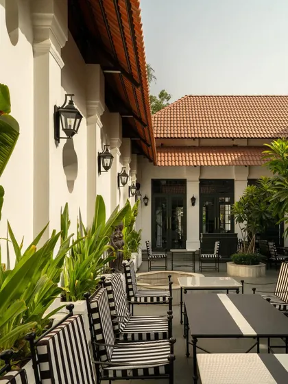 Views of the courtyard at Elgin Cafe, a space designed for pause and reflection. I used white lime-washed walls, lush tropical plants, and classic lantern-style lighting to create an intimate, serene outdoor dining experience.