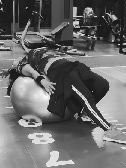 Using a stability ball for a full-body stretch. This is a great way to improve flexibility and core strength, and I often incorporate it into my Pilates and cool-down sessions.