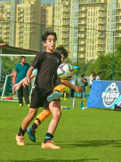 A player controls the ball on their chest, showing advanced skill.