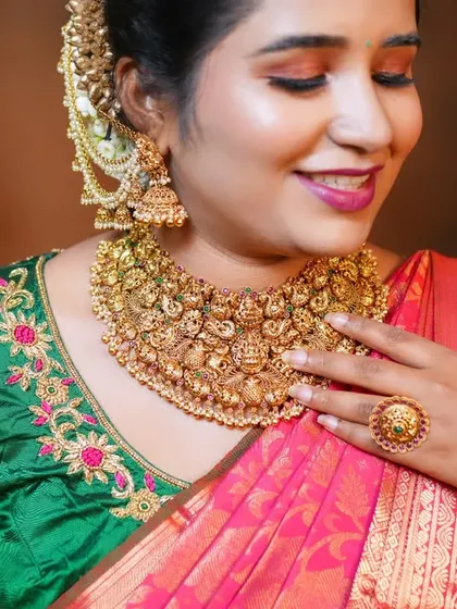 A close-up of the bride's smile, framed by the exquisite antique choker. The intricate details of the jewellery are designed to make you feel special and look timeless.