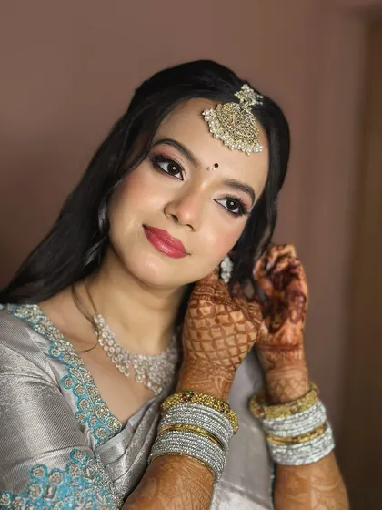 A confident and beautiful portrait. The makeup is designed to enhance her features, with a focus on her expressive eyes and flawless skin.