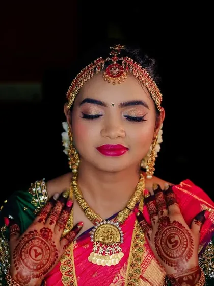 An artistic bridal portrait using a ring light against a dark background. This technique highlights the bride's features and traditional attire.