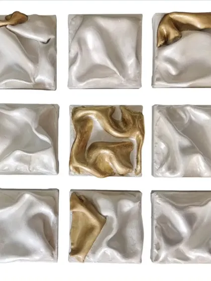 This is 'The Dancing Squad', a nine-panel abstract installation. The silver panels create a sense of unified, flowing movement, while the gold pieces act as lead performers, adding energetic bursts of light and contrast to the composition.