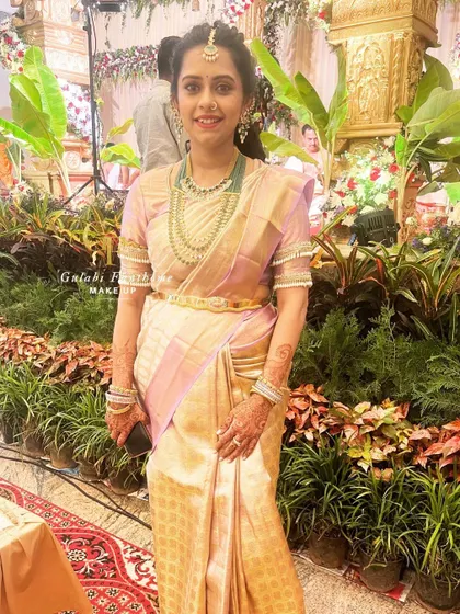 A full-length shot showing how the entire look, from makeup to her traditional attire, comes together elegantly.