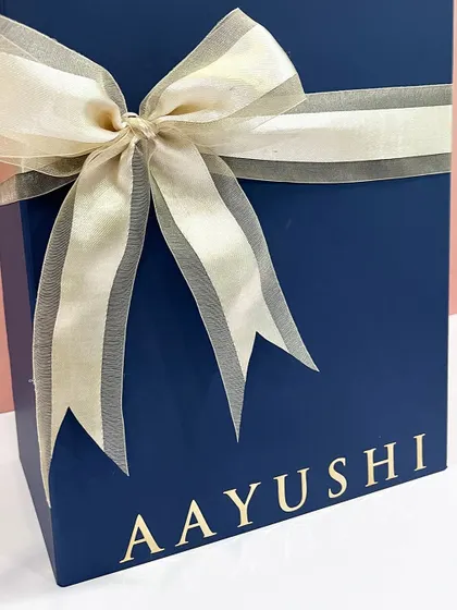 A close-up of the beautiful satin organza ribbon and personalized name on the groomsmen advent calendar box.