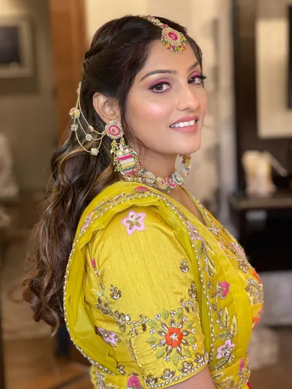 A side profile of the Haldi bride, her unique hairstyle looking beautiful.