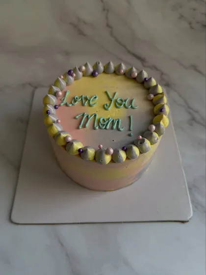 A colorful pastel cake for Mom, with a soft rainbow gradient and "Love You Mom!" piped on top.