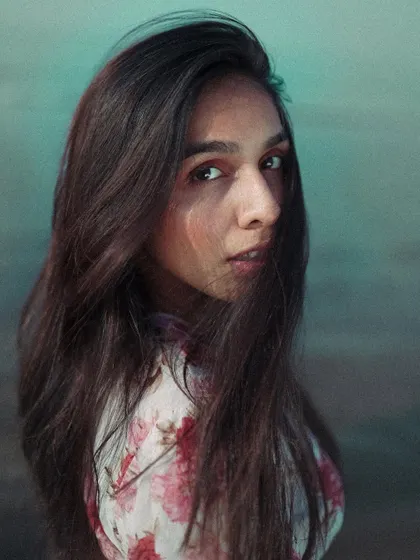 This is a close-up portrait where I played with hair movement to add a sense of candidness. The direct gaze of the model creates a strong connection with the viewer, making the image engaging.