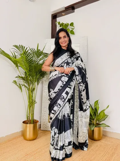 For those who love monochrome, this black and white printed workwear saree is a perfect choice. The unique print is eye-catching, and the satin fabric feels very smooth.