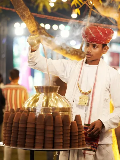 A server pours hot, aromatic masala chai at our traditional tea station. It's these small, authentic touches that make an event special.