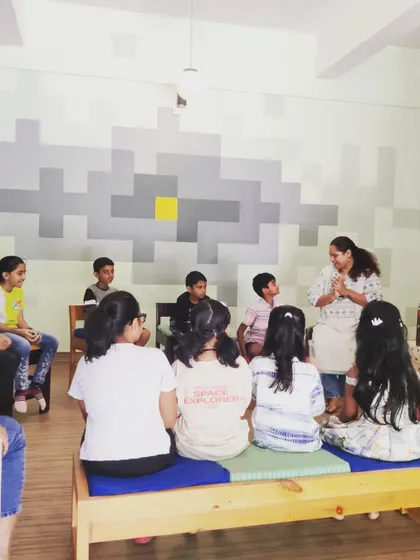 A view from the back of the room, showing the group completely focused on the storyteller. We work hard to command the room with just the power of a good story.