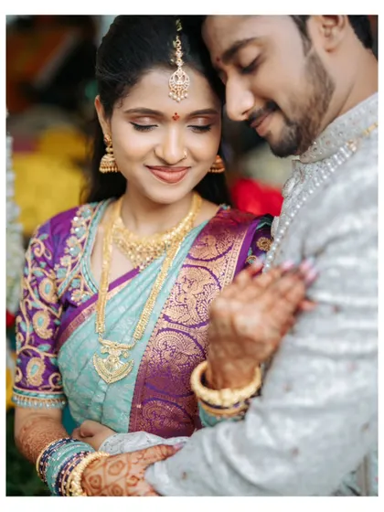 A tender close-up of the couple during their engagement shoot. The intricate details of the bride's saree and jewelry are beautifully highlighted.