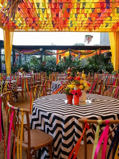 The guest dining area at the carnival, with chevron-print tables and chairs decorated with colorful ribbons, creating a cohesive and lively look.