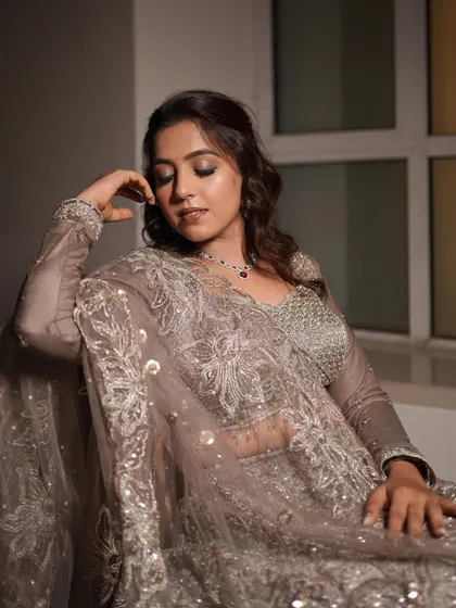 An elegant portrait of an engagement bride in a sophisticated grey lehenga. The makeup is soft and romantic.