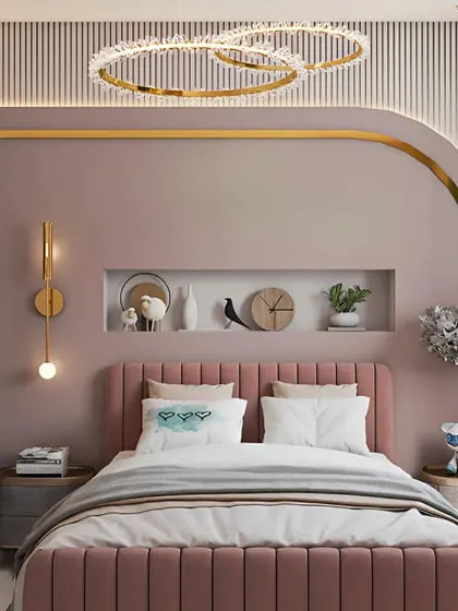 A beautiful and feminine bedroom design in shades of pink and gold. The arched niche and statement chandelier add a touch of glamour, while the integrated desk provides a functional workspace.