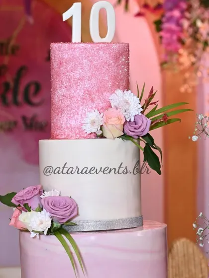 A beautiful pink and white tiered cake for a 10th birthday and Aqeeqah celebration. The cake is decorated with fresh flowers, blending the two special occasions perfectly.
