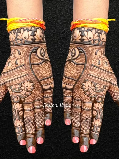 A classic symmetrical bridal design with peacocks and lotus flowers, perfect for a traditional bride.