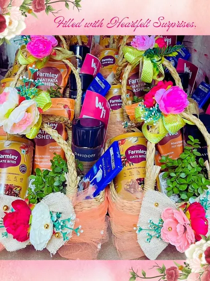 Heartfelt surprises prepared for a bulk order. These wicker baskets are filled with Farmley snacks, Davidoff coffee, and other gourmet items, each decorated with colorful flowers for a personal touch on a large scale.