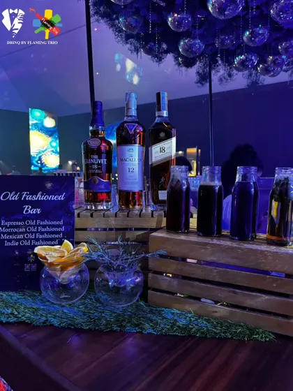 The full setup of our Old Fashioned Bar, featuring premium whiskies and pre-mixed infusions. The rustic wooden crates and fresh garnishes complete the sophisticated look.