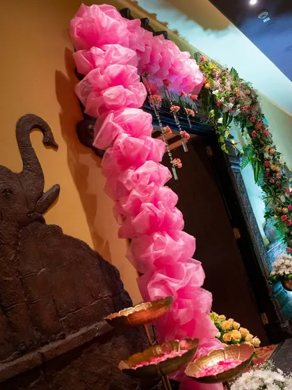 The lotus theme continued down the hallway with this beautiful pink floral archway. Every detail was carefully considered to create a cohesive and immersive experience for the naming ceremony.