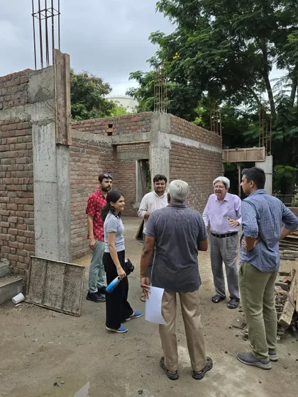 **Dwelling in Frames, Ahmedabad:** Our team and clients in discussion on the construction site. We see every project as a collaborative journey with our clients, whom we consider our "co-passengers."