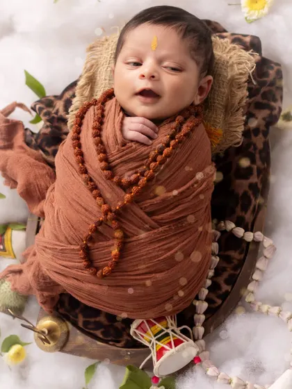 Another precious, authentic moment. This newborn, dressed as Lord Shiva, makes a tiny sound, adding to the story of his session.