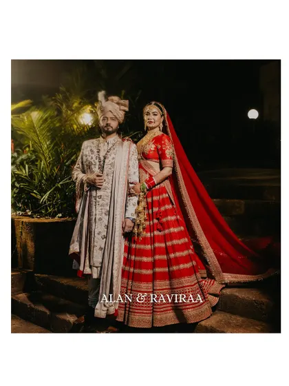 A classic portrait of the bride and groom on their wedding day. This image captures the regal elegance of their Sabyasachi outfits and the timeless love they share, a perfect memory from their celebrity wedding in Goa.