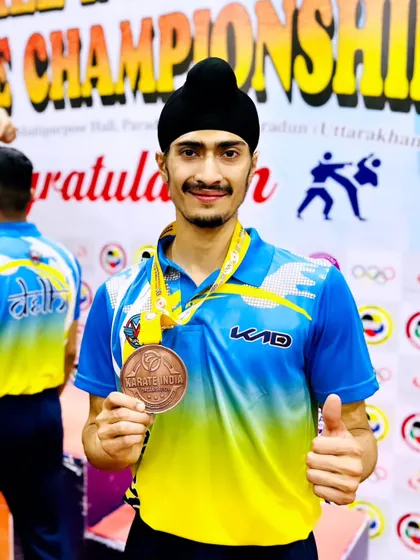 Holding my Bronze medal for the Delhi Team event. Winning for my team is often more important than individual glory.