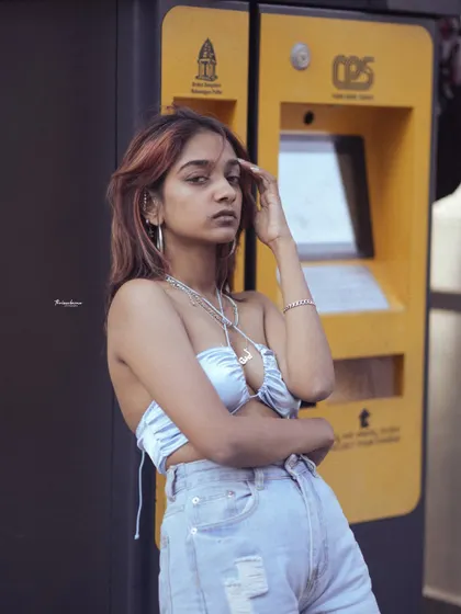 This street portrait uses the yellow parking meter as a pop of color against the model's cool-toned outfit. I look for these details in the environment to make an image stand out.