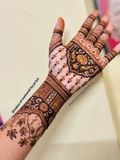 A beautiful example of a semi-bridal or engagement design that covers the hand and arm with elegant, flowing patterns.