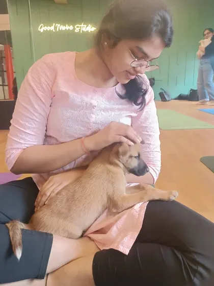 A participant shares a quiet moment with a sleepy puppy after class. These interactions are incredibly therapeutic.