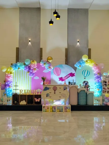 A hot air balloon themed party setup in a large hall.