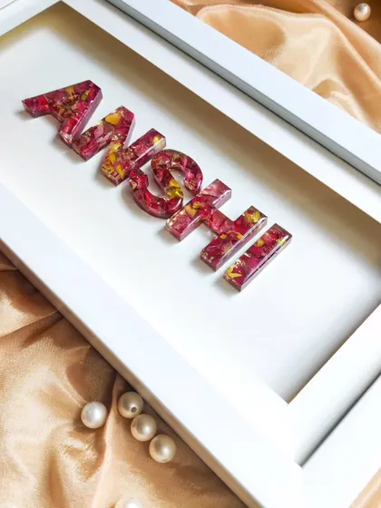 A personalized name shadow frame, with each letter filled with real preserved flowers. This makes for a unique and beautiful gift for any occasion, from birthdays to baby showers.