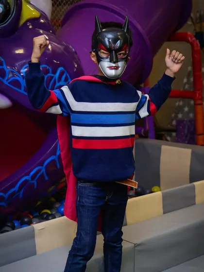 Batman strikes a power pose! It's so much fun to see kids become their favorite superheroes for a day in our play zone.