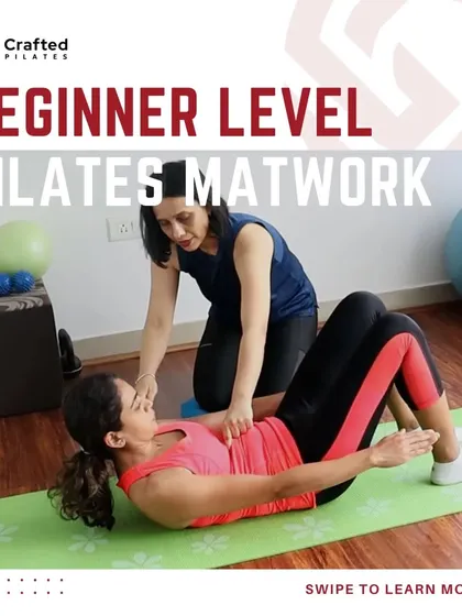 This image shows me guiding a student through the initial phase of an ab prep, ensuring she maintains a neutral pelvis and engages her deep core muscles correctly.