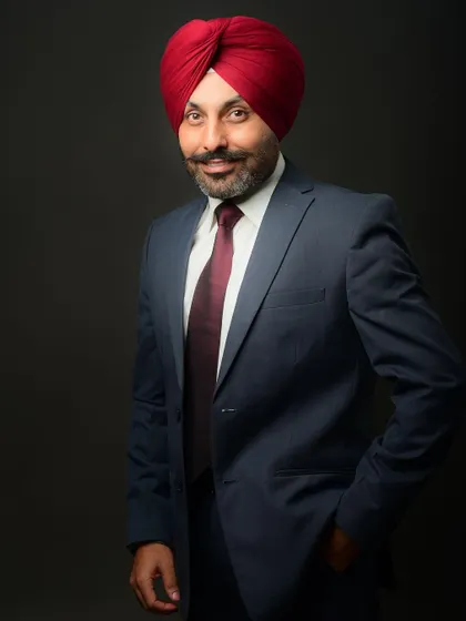 A confident three-quarter length studio portrait. This is a standard and highly effective pose for any corporate professional.