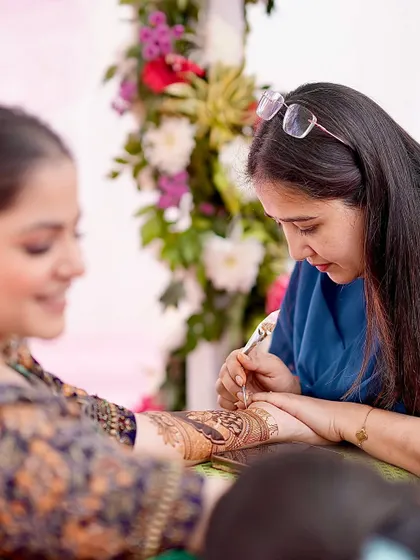 Focused on the art. Every stroke is placed with care and intention, ensuring the final design is as perfect as the bride's vision.