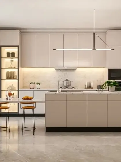 An open-concept kitchen featuring an island with a breakfast counter. The minimalist, handleless cabinets in a neutral beige tone create a spacious and airy feel, perfect for modern living.