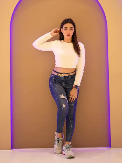 A simple, clean studio shot with an arched backdrop and purple accent lighting. This is great for creating modern portraits for influencers.