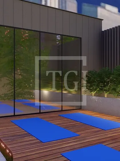 A proposed design for a Mumbai project, showing a dedicated outdoor yoga and wellness area with wooden decking, surrounded by lush planters against the city skyline.