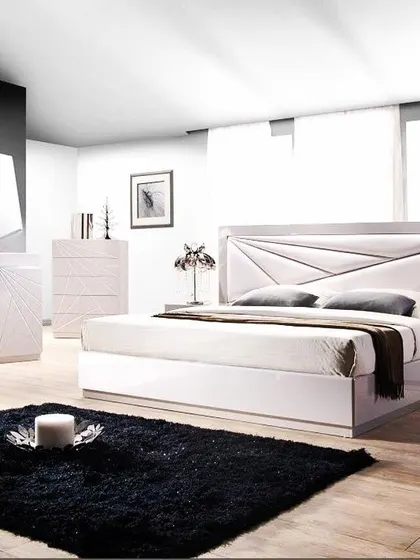 This image shows a complete modern bedroom set in a striking black and white theme. The bed features a geometric, paneled headboard, complemented by matching bedside tables and a dresser, all in a high-gloss white finish for a sleek, contemporary look.