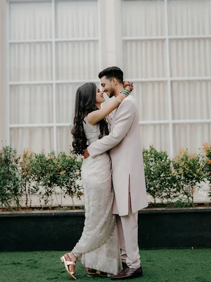 A full-length portrait showcasing their beautiful coordinated outfits and their happy, loving gaze. A perfect shot for an engagement announcement.