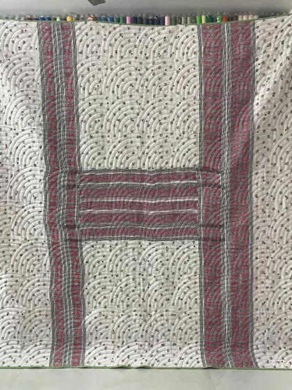 A collection of reversible memory quilts crafted from the sarees of a client's mother. Each side tells a different story, preserving the fabric's patterns and colors in a new, functional form.