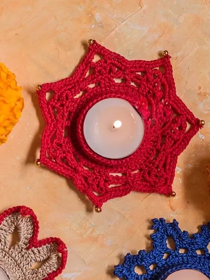 A vibrant flat-lay of our star-shaped and flower-shaped diya holders. This shows the variety of designs and colors we offer, allowing you to create a truly personalized festive arrangement.