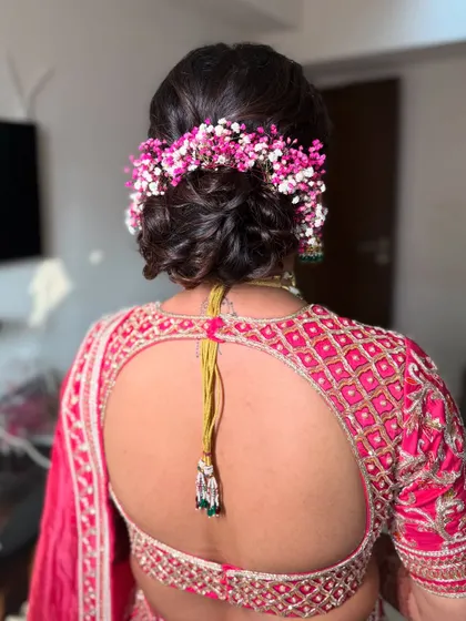 This angle shows the fullness of the floral arrangement on the messy bun, creating a beautiful crown effect at the back.