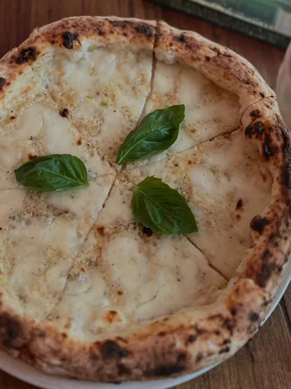 Our Pizza Bianca, sliced and ready to be enjoyed. A simple yet elegant choice.