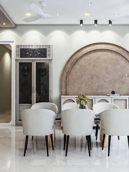 Here you can see how the dining area flows seamlessly from the living space. The white contemporary dining chairs contrast beautifully with the dark legs, and the entire setup is positioned to take advantage of the natural light from the large windows.